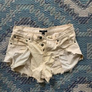 Women’s white daisy duke  shorts, frayed and torn.